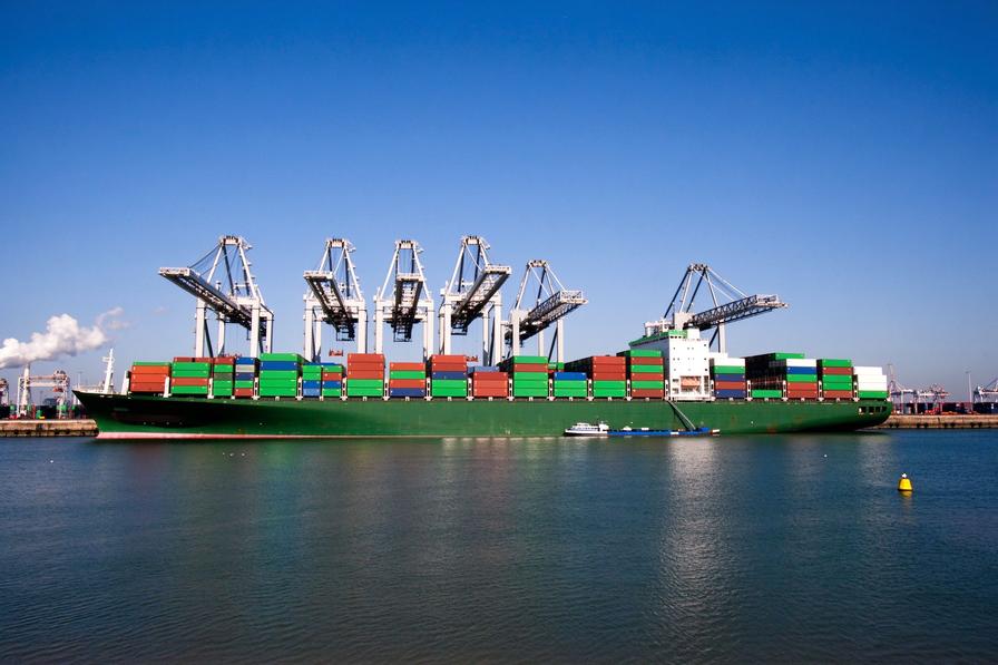Container ship and gantry cranes in a harbour