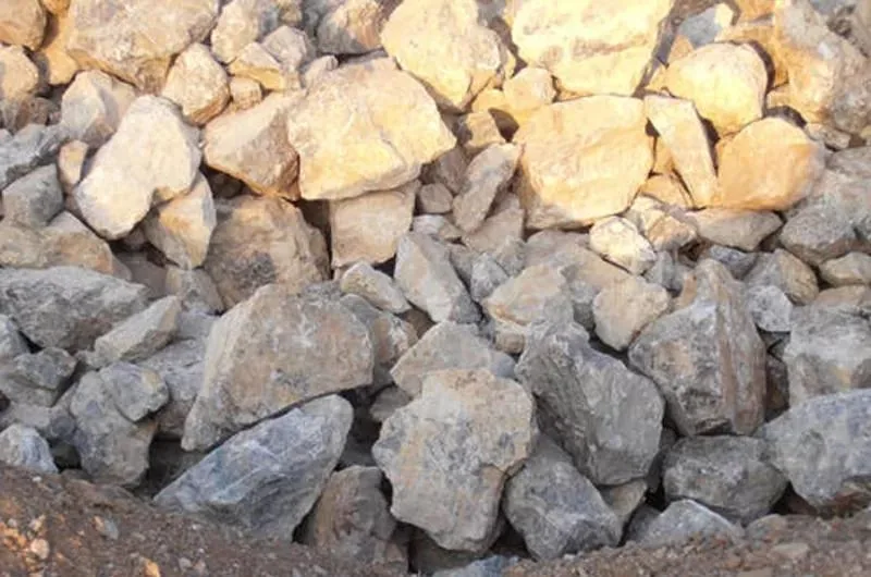 Pile of raw phosphate rock with beige and brown stones