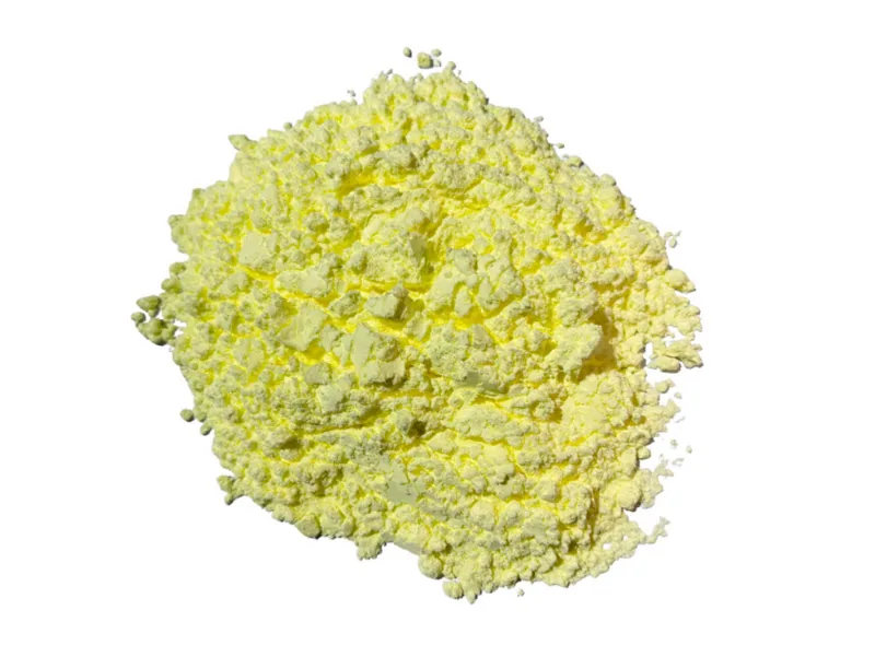 Fine yellow sulfur powder piled on a white surface